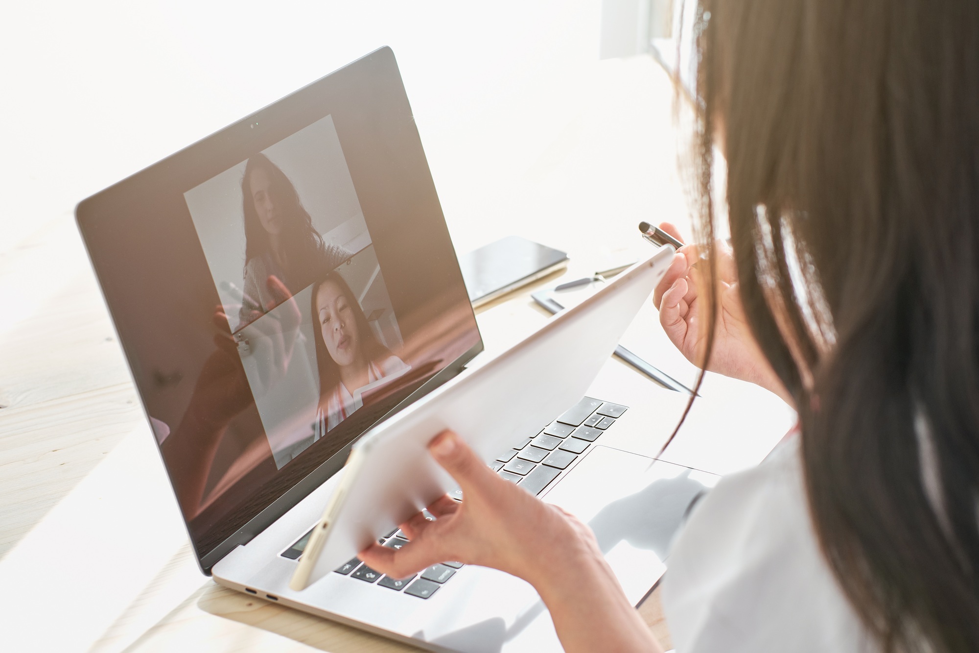 Asian doctor using tablet during online consultation with patien